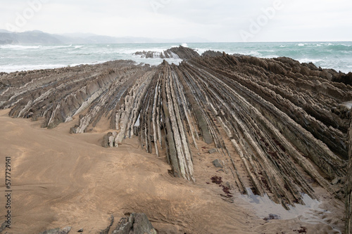 View on steeply-tilted layers of flysch geological formation on Atlantic coast at Zumaia, Basque Country, Spain