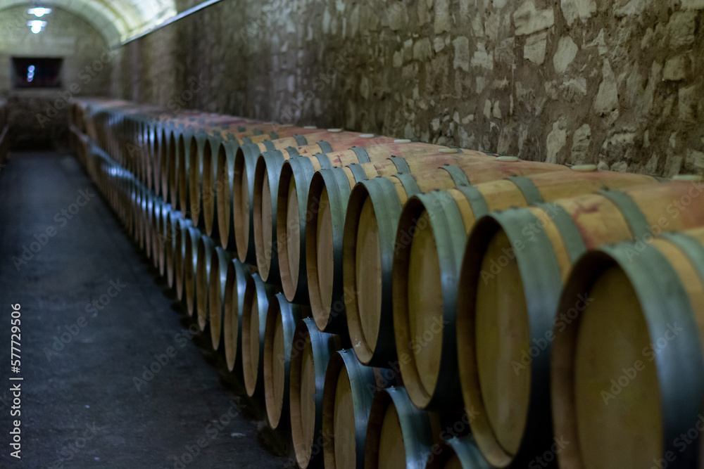 Old french oak wooden barrels in cellars for wine aging process, wine making in La Rioja region, Spain Old french oak wooden barrels in cellars for wine aging process, wine making in La Rioja region, Spain