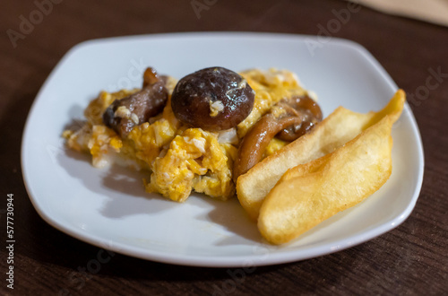 Homemade scrambled eggs with forest mushrooms