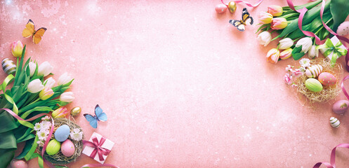 Easter background. Colorful spring tulips with butterflies and painted eggs