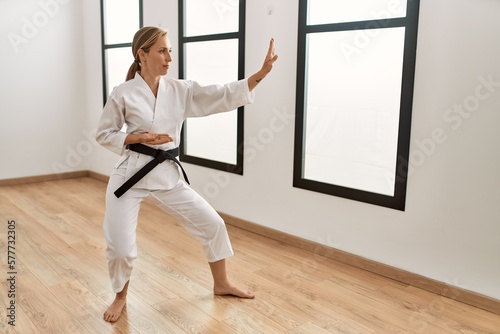 Young caucasian woman training karate at sport center