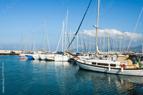 Beautiful pier with luxury yachts on the blue sea shore under the hot summer sun