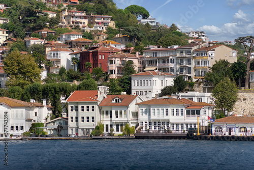 View from Bosphorus strait of the green mountains of the Asian side, with traditional houses and dense trees in a summer day, Istanbul, Turkey photo