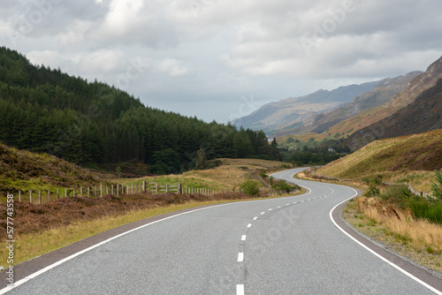 Fototapeta Naklejka Na Ścianę i Meble -  A winding road in the middle of mountais in the Highlands, Scotland