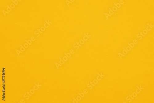 Texture of yellow fibrous paper, cardboard, close-up. Paper background, embossed surface.	