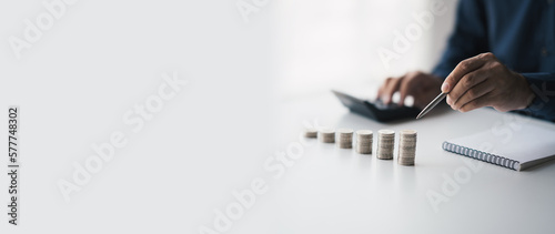 Money saving concept, accountant counting and calculating annual financial budget.