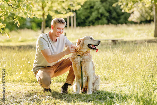 Man walking golden retriever