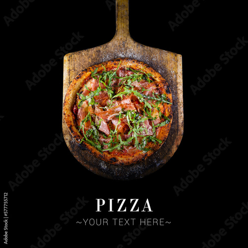Top view of classic Italian uncut Parma ham pizza with tomatoes, mozzarella cheese and fresh arugula leaves served on baking shovel. Cheesy pizza isolated on black background with text and copy space
