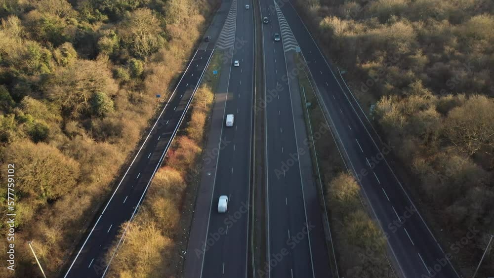 ascending fly drone footage on multiple lane motorway cross junction exit