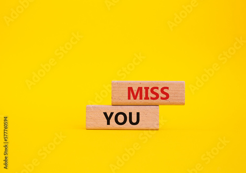 Miss you. Concept word Miss you on wooden cubes. Beautiful yellow background. Business and Miss you concept. Copy space.