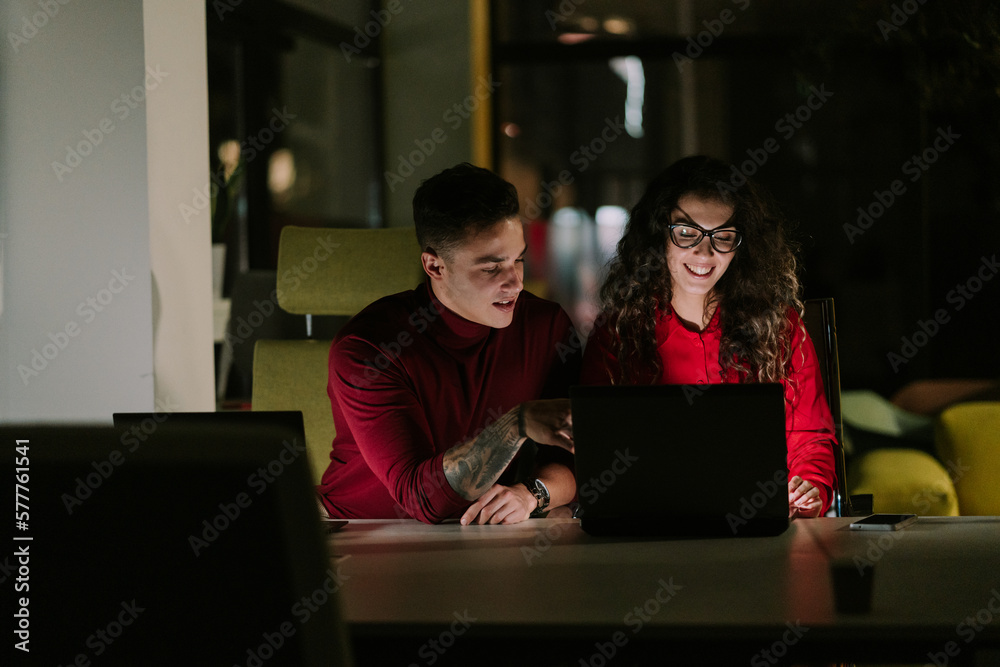 Lovely business couple working late night at the office and having fun conversation. Close up photo Lovely business couple working late night at the office and having fun conversation. Close up photo
