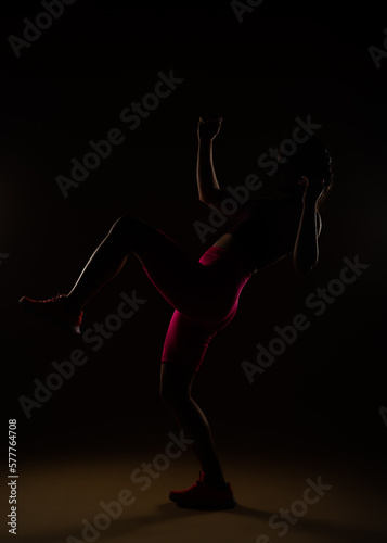 Strong woman practising knee kicks