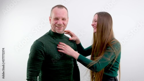 comic photo woman is angry at man strangling him with both hands behind neck smiling and closing eyes at man behind pigtail white background relationship anger game priority in family daughter father photo