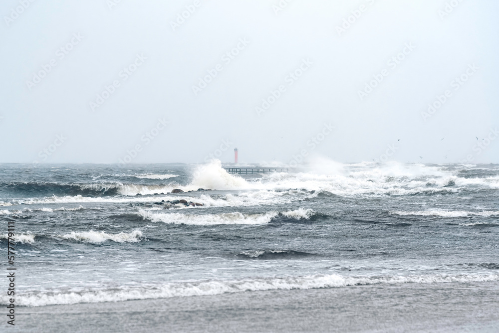 Stormy winter day at baltic sea on Mangalsala pier in Riga