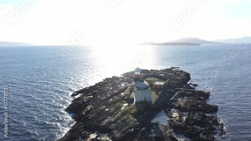 Aerial footage Roancarrigmore Lighthouse, Bantry Bay, West Cork, Ireland 4K
Shot by a drone which flies in orbit. Rocky coast and rough sea waves. photo