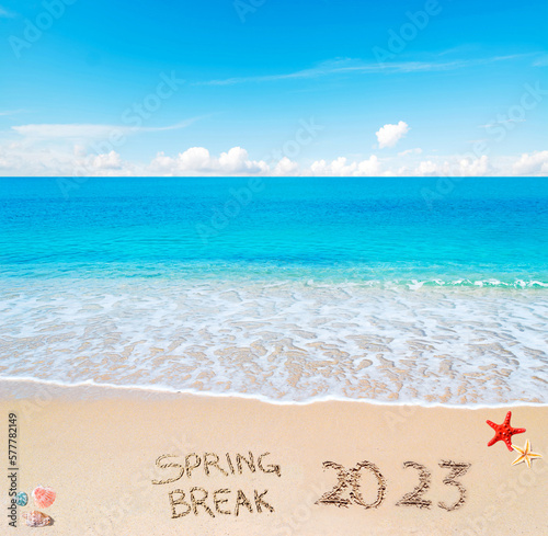 spring break 2023 written on the sand
