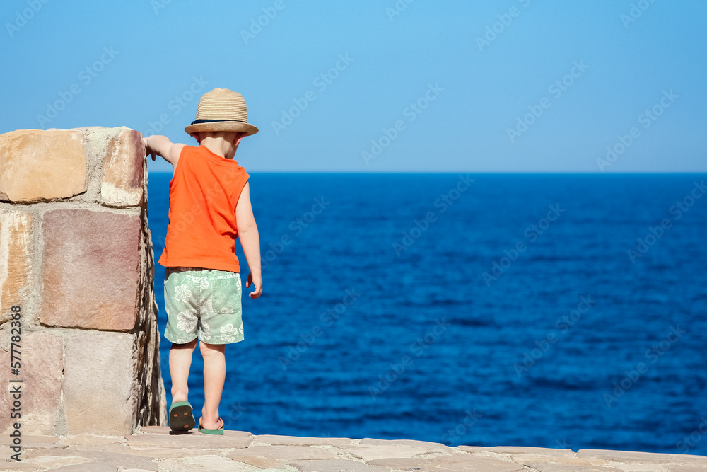Happy child playing on the sea background
