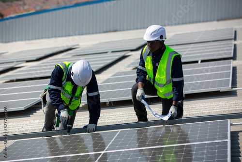 Installing solar photovoltaic panel system. Solar panel technician installing solar panels on roof. Alternative energy ecological concept. © FotoArtist