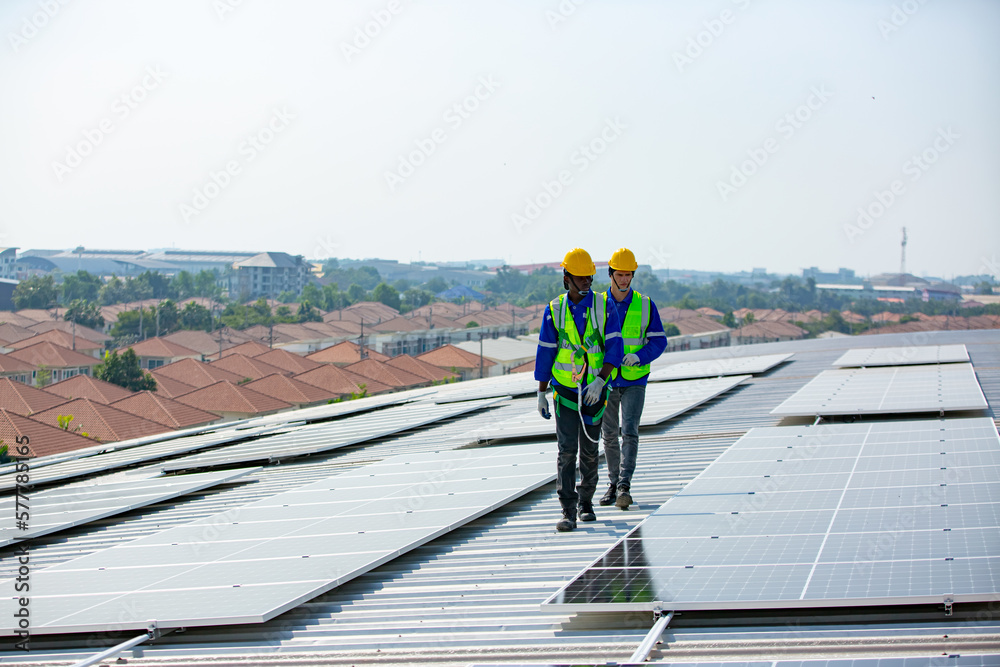 Engineer service check installation solar cell on the roof of factory. technician checks the maintenance of the solar panels, engineering team working on checking and maintenance in solar power plant