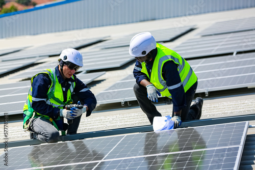 Workers assemble energy system with solar panel for electricity