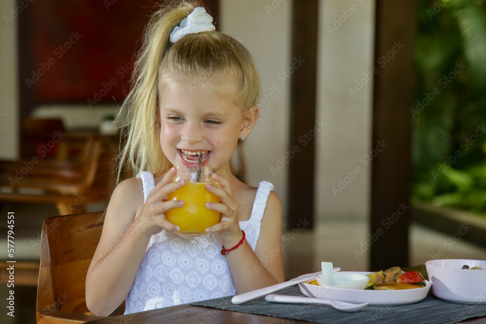 Adorable 5 years old girl having breakfast in the restaurant Adorable 5 years old girl having breakfast in the restaurant