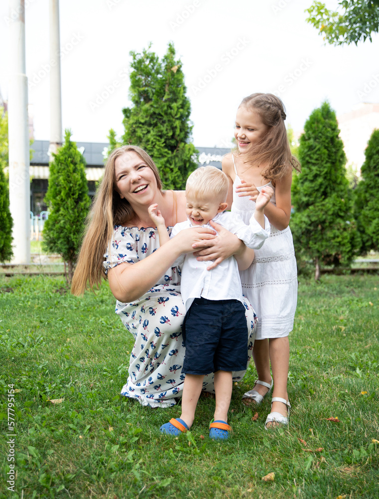 Obraz premium People laugh emotionally. Mom children have fun together.