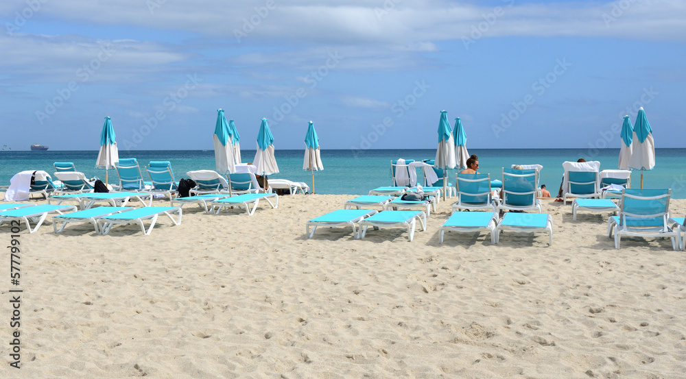 View of beach with sun loungers and umbrellas at South Pointe on winter sunny day. Miami Beach, Florida
