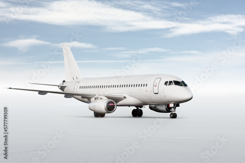 White passenger aircraft isolated on bright background with sky