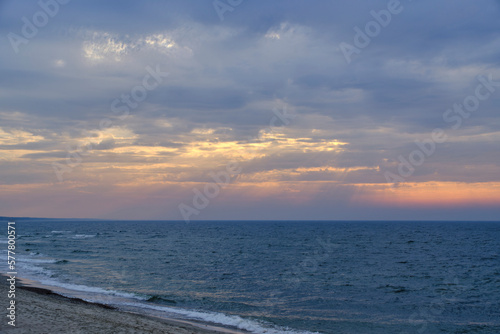 Sunset on shore sandy beach Baltic Sea.