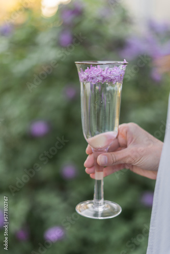 a glass with lilac flowers