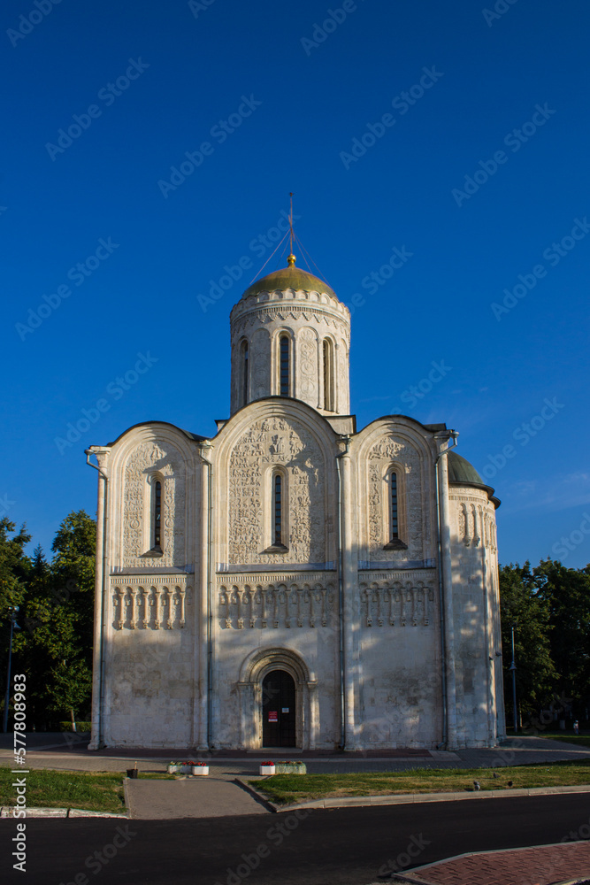 VLADIMIR, Russia - AUGUST, 17, 2022: old white-stone Dmitrievsky Cathedral with a golden dome close-up on a sunny summer day