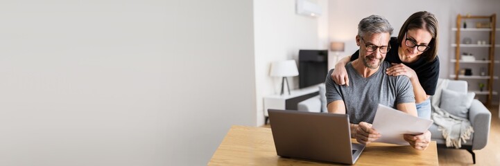 Couple Doing Taxes And Family Budget