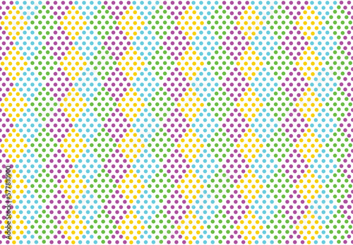 Seamless pattern of colored dots. Colorful repeated pattern. Vector.