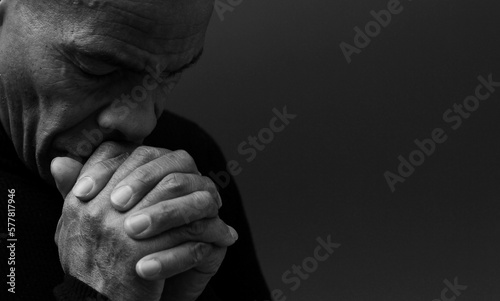 people praying to god at home on black background with people stock photo