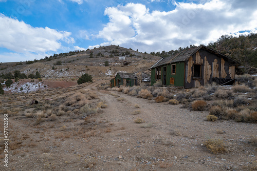 Shacks in ruins along a dirt road at an abandoned mine in Nevada, USA