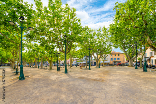 Fototapeta Naklejka Na Ścianę i Meble -  The spacious tree lined Place des Lices town square and park in the historic center of Saint-Tropez, France, along the Cote d'Azur French Riviera. 