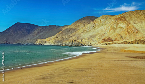 Beautiful deserted lonely pacific ocean bay, empty sand beach, turquoise water, barren arid desert mountains - North Chile, Atacama region