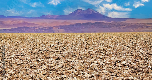 View over endless dry salt flat crust on blurred mountain range  volcano Licanabur - Salar de Atacama  Chile