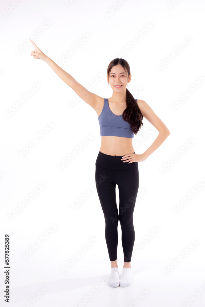 Obraz premium Portrait of beautiful young asian woman in sportwear smile and presenting isolated on white background, sport and exercise for health and weightloss, female and slimming showing something.