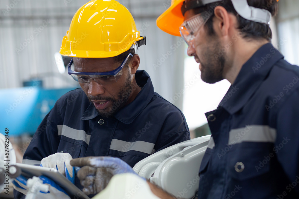 Two engineer man working with machine robot automatic together at factory, technician maintenance and improvement while examining ai of robot and control with remote, industry and innovation concept. Two engineer man working with machine robot automatic together at factory, technician maintenance and improvement while examining ai of robot and control with remote, industry and innovation concept.