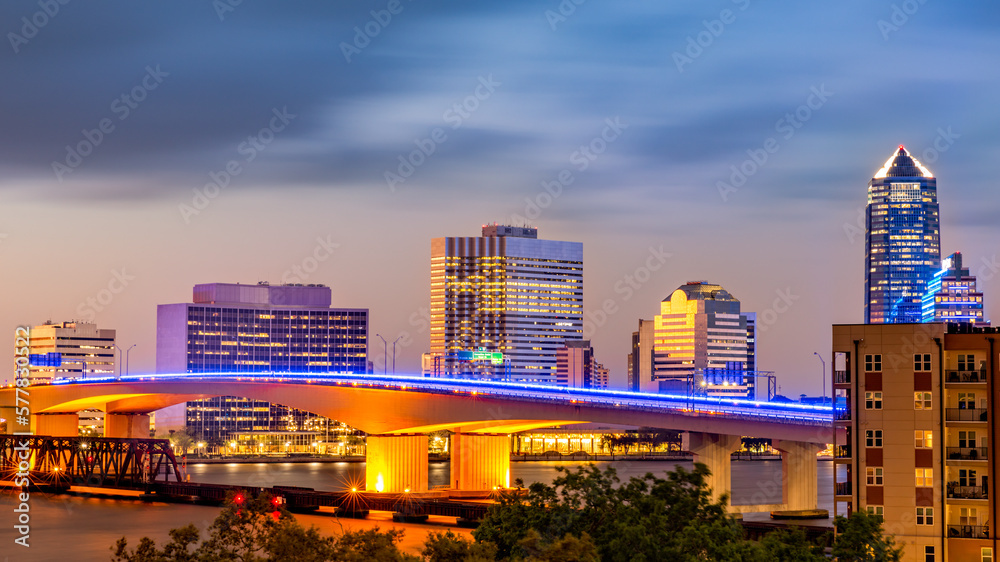 Long exposure of Jacksonville, Florida skyline and Acosta bridge spanning St. Johns river, at dusk. Jacksonville is a city located on the Atlantic coast of northeastern Florida.