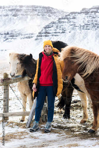 the girl is photographed against the background of northern horses in Iceland photo