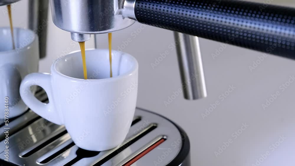 Close up 4k video of coffee machine making espresso and female hand grabbing cup to drink. Close up 4k video of coffee machine making espresso and female hand grabbing cup to drink.