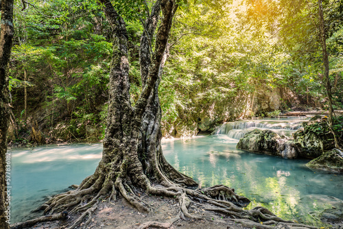 Fantasy majestic forest landscape with trees, river and waterfalls with sunlight and dreamy atmosphere, shot at Erawan Waterfall National Park, Thailand