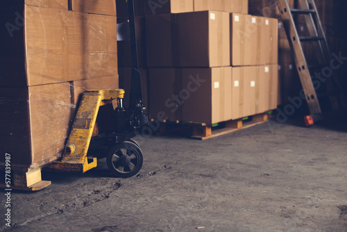 Forklift pallet truck stacker in warehouse loading boxes