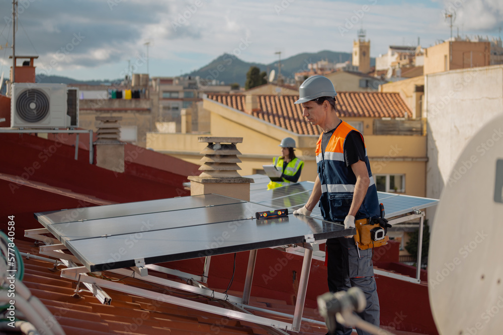Naklejka premium Solar energy engineering team working on photovoltaic panels