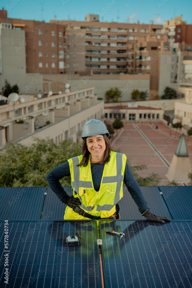 Female electrician engineer portrait by urban Solar Panels in city roof Female electrician engineer portrait by urban Solar Panels in city roof