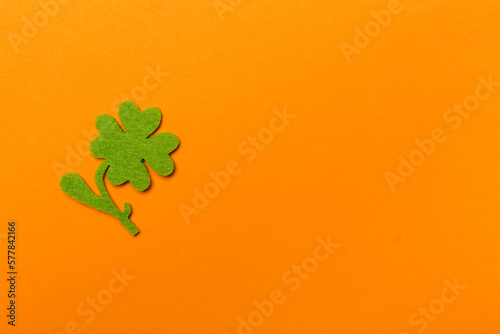Felt clover on color background, top view. St. Patricks day concept
