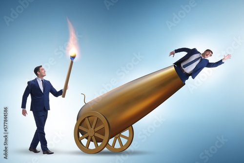 Concept of lay-off with businessman and cannon Fototapet