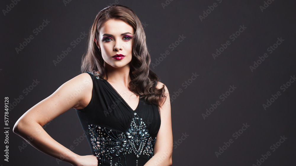 Gorgeous young brunette in a chic evening look. Scarlet lips and eye shadow, wave hair styling Gorgeous young brunette in a chic evening look. Scarlet lips and eye shadow, wave hair styling